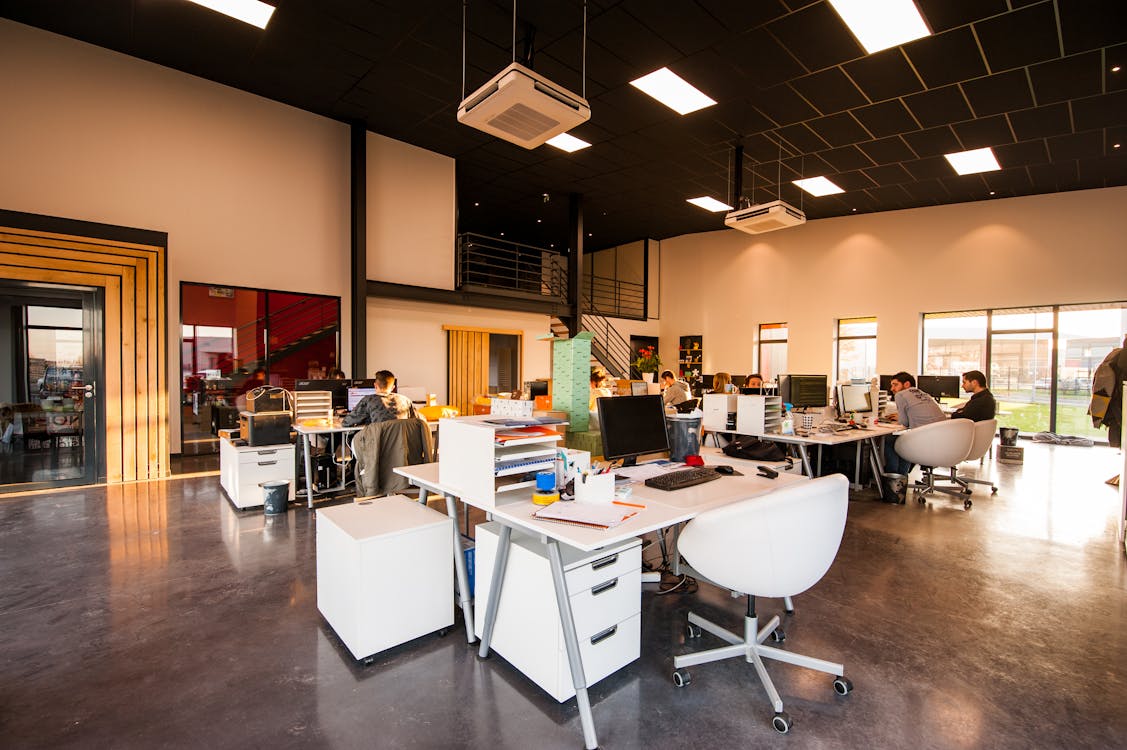 Modern open-plan office with ceiling lighting grid